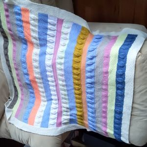 Handmade rainbow quilt with raised leaves made by grandmother.